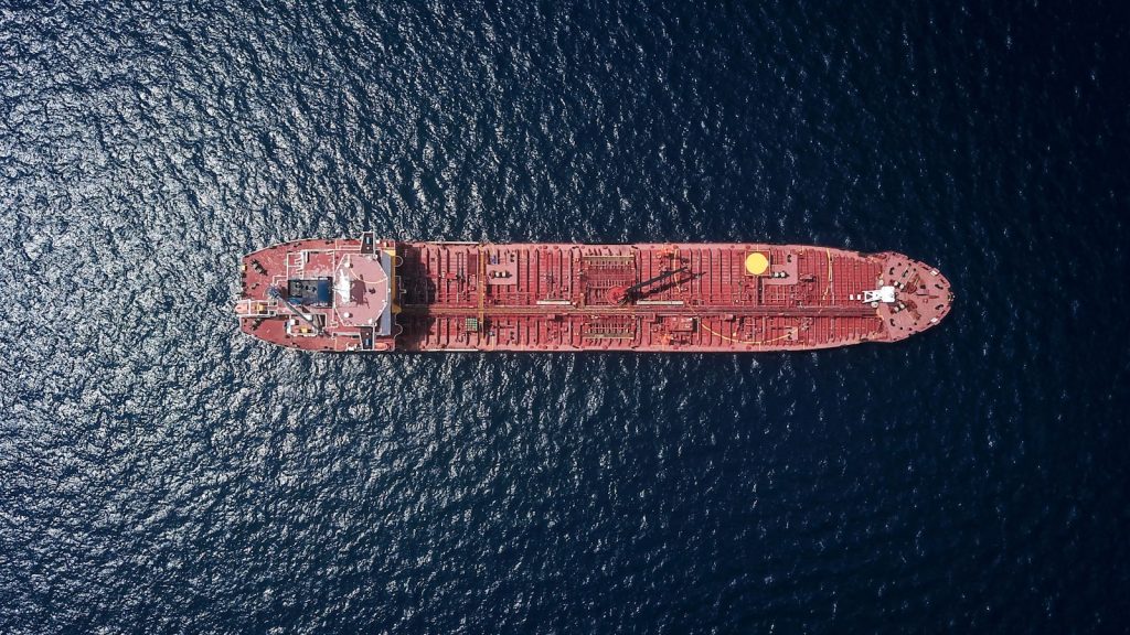 Aerial view of an oil tanker on dark ocean, symbolizing the Strait of Hormuz crisis