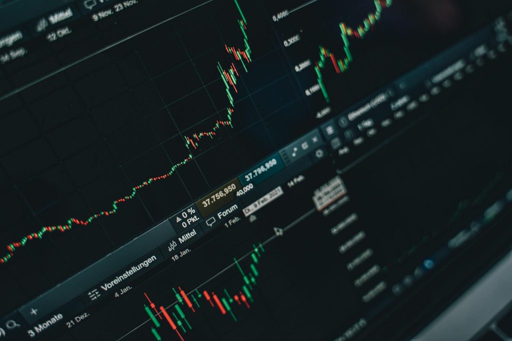 Wall Street trading screen with green stock charts representing the NACHO Trade May 2026